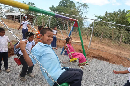 Children swinging on playset